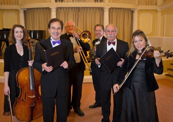 L to R Kayleigh Simpson, Norwich Philharmonic, Roger Holden, Hansells Managing Partner, Roger Holden, Hansells Managing Partner, Gill Seaton Norwich Phil. Back L to Right Norwich Philharmonic’s Robert Slocombe and Michael Nutt 