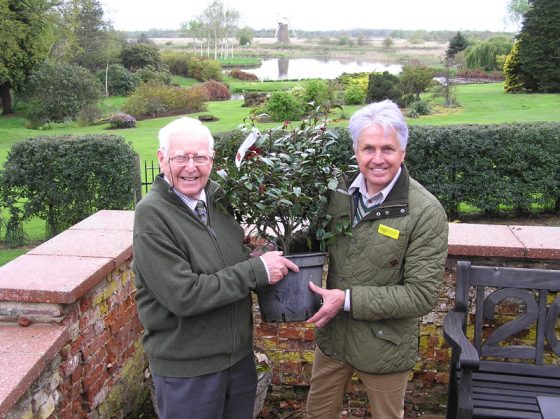 NGS Ambassador Alan Gray presenting Peter Boardman(on left) with a rare Camellia in 2012 to celebrate 30 years of opening his garden for the National Gardens Scheme 